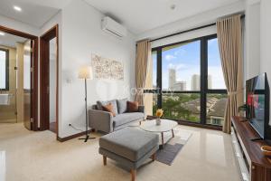 a living room with a couch and a table at Avalon by Kozystay - BSD in Tangerang