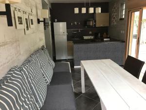 a living room with a table and a kitchen at La Croix du Sud 2 - Bas de Villa Cilaos in Cilaos
