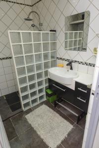a bathroom with a sink and a mirror at La Croix du Sud 2 - Bas de Villa Cilaos in Cilaos