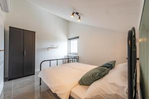 a bedroom with a bed in a room with a window at Master Road House in Maslenica