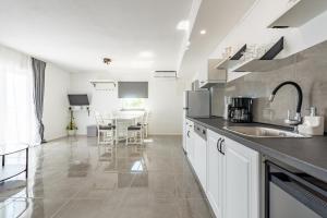 a kitchen with a sink and a table at Master Road House in Maslenica