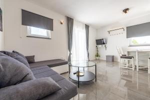 a living room with a couch and a table at Master Road House in Maslenica