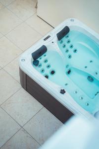 a jacuzzi tub sitting on a tile floor at Maison Balas in Canet-en-Roussillon