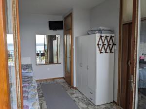 a hallway with a white refrigerator in a room at Appa Apartments in Portorož