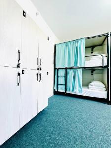 an empty room with two bunk beds and cabinets at Asia Hostel in Shymkent