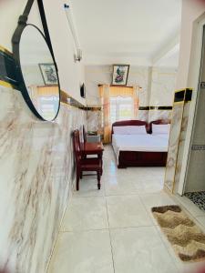 1 dormitorio con cama y espejo en Hoa Bien Motel, en Ly Son