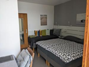 a bedroom with a bed and a couch at Appa Apartments in Portorož