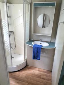 a bathroom with a sink and a shower with a mirror at EURL kaza évasion services in Cabariot +85 photos