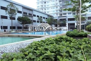 a swimming pool in the middle of a building at Le Thompson - Puchong Center IOI Mall in Puchong