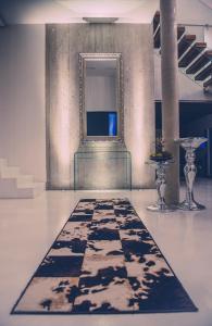 a room with a black and white rug on the floor at Weingut Holler Chalet in Spielfeld