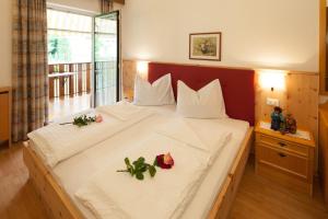 a bedroom with a large bed with flowers on it at Residence Preyhof in Caldaro