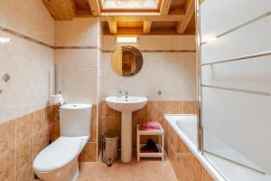 a bathroom with a toilet and a sink and a tub at Chalet Etoile in Saint-Jean-d'Aulps