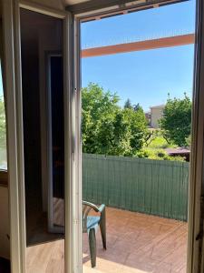 a sliding glass door with a chair on a patio at Ruti's House in Cassano Magnago