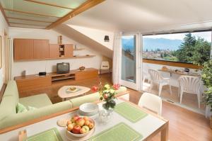 a living room with a couch and a table at Residence Preyhof in Caldaro