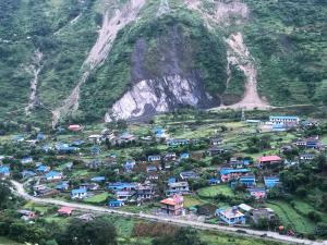 an aerial view of a village in a mountain at Bless Break Guesthouse in Narcheng