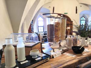a room filled with lots of items on a wooden table at Schloss Hotel Wurzen in Wurzen