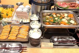 a buffet of food with vegetables and meats on a table at Hotel Courtland in Nagano