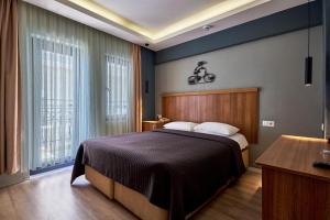a bedroom with a bed and a large window at Aqua Princess Hotel in Kaş +161 photos