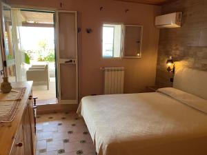 a bedroom with a bed and a door to a patio at appartamento in Pantelleria