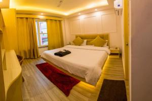 a bedroom with a large bed and a window at Hotel The Moksham in Rishīkesh