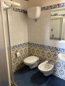 a bathroom with a toilet and a sink at appartamento in Pantelleria