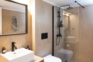 a bathroom with a white sink and a shower at Escape Stay Center Xanthi - Private Parking - MenoHomes 4A in Xanthi