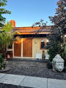 a house with a statue in front of it at Rumah Pathuk Syariah Homestay in Yogyakarta