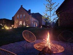 a fire pit in a yard in front of a house at Domek pod Klonem in Lubliniec