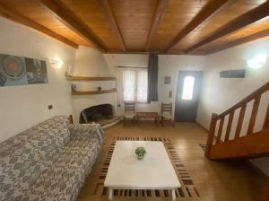 a living room with a couch and a table at Agnanti Villas 2 in Isómata