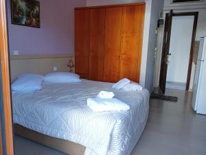 een slaapkamer met een bed met handdoeken erop bij studio nufaro in Mytilini