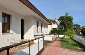 a balcony of a house with a table and chairs at Appartamenti Vanin Ca' di Valle in Cavallino-Treporti