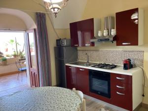 a kitchen with a sink and a stove top oven at sala in Scauri