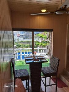 a porch with a table and two chairs and a view at THE WISH RESIDENCE BEACH SIDE KOLUPITIYA Colombo 3 in Colombo