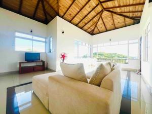 a living room with a couch and a television at Rockview Gardens Homestay in Kandy