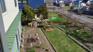 a garden on the side of a building at Casa YuriMomo in Date