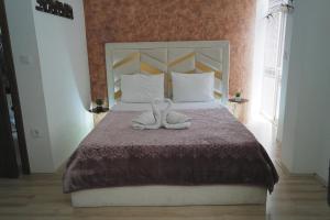 a bedroom with a bed with two towels on it at Rooms Filip in Bitola