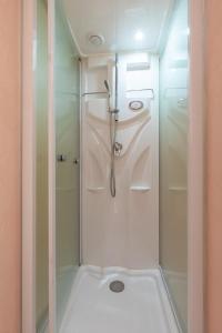 a shower with a glass door in a bathroom at Populus-club Otaru - Vacation STAY 91869v in Otaru