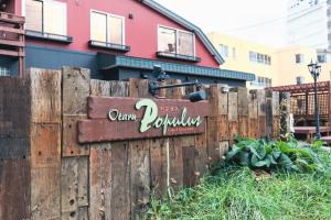 a sign on a wooden fence in front of a house at Populus-club Otaru - Vacation STAY 91869v in Otaru