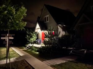 a house at night with the lights on at fajnemorze - Domy Szwedzkie in Dębina-Ustka