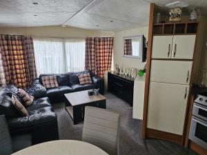 a living room with a couch and a table at Tudor Lodge Hotel in Nottingham