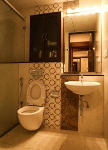 a bathroom with a toilet and a sink at Luxury Hill Top Apartment by EWA Properties in Mangalore +21 photos