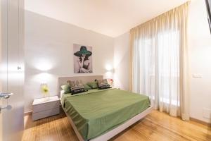 a bedroom with a green bed and a window at COCO SUNSHINE Apartment TAORMINA in Taormina +23 photos