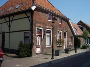 a brick building with a street light in front of it at Hotel Bertram in Bredevoort