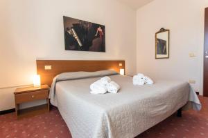 a hotel room with a bed with towels on it at Hotel Moranna in Lido di Camaiore