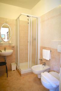 a bathroom with a shower and a toilet and a sink at Villa Gaia in Portoferraio