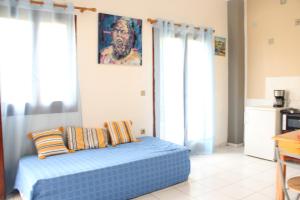a bedroom with a blue bed in a room at Rodi Apartment 2 in Kamari