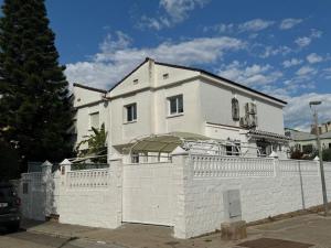 a white house behind a white fence at Casa Estrella Gandia in Gandía