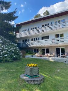 a large white building with a bunch of flowers at Willa MARANT in Szklarska Poręba