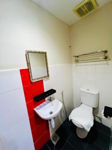 a bathroom with a white toilet and a sink at Swing & Pillows -MyHome Hotel Wangsa Maju in Kuala Lumpur