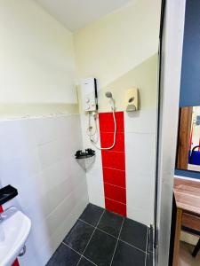 a bathroom with a shower with a red stripe at Swing & Pillows -MyHome Hotel Wangsa Maju in Kuala Lumpur